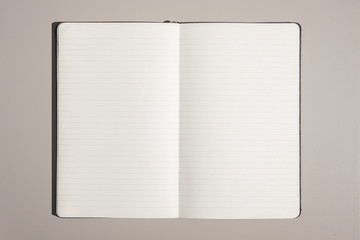 Light office desk table with laptop and supplies with blank notebook. Top view with copy space, flat lay.