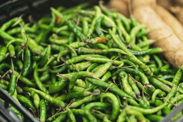 Green chilli peppers in market