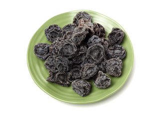 Dried black plums isolated on white background