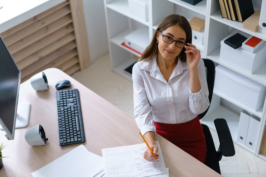 Young beautiful businesswoman work with documents fill in blank