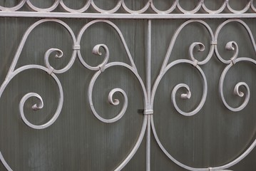 gray metal texture wrought pattern on the wall of the fence