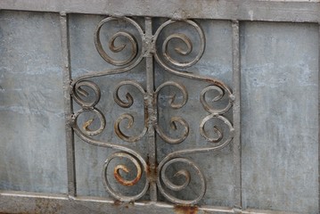 gray background of metal wrought pattern on the wall of the fence