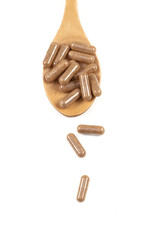 Fish oil capsules with omega 3 and vitamin D in a wooden spoon on white background, healthy diet...