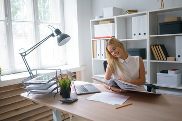 young beautiful woman work at office with documents sit at table study information