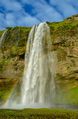 Close up profile view of iceland waterfall seljalandsfoss with rainbow 