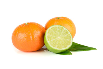 Fruit assortment of tangerine and lime with leaves isolated on white background
