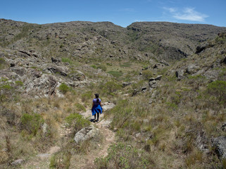 A hiker at Cerro Blanco reserve, near Tanti and Los Gigantes in the Altas Cumbres region, Cordoba, Argentina.