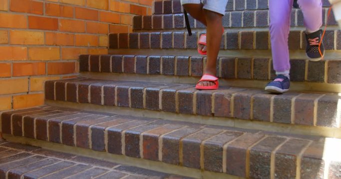 Schoolkids walking down staircase of elementary school 4k