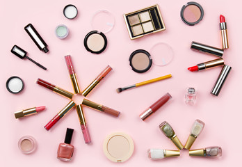 Set of woman's cosmetics on pink background. Women's secrets. Decorative cosmetics: highlighter, concealer, rouge, palette with eye shadows and brushes for face make up, face sculpture . Make up.