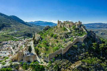 Obraz premium Moclin medieval walled town and ruined castle with blue sky aerial panorama