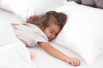 Fototapeta na wymiar Cute little girl sleeping in cozy bed