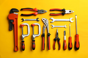 Flat lay composition with construction tools on color background