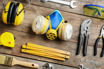 Flat lay composition with construction tools on wooden background