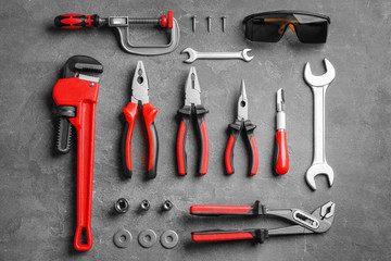 Flat lay composition with construction tools on grey background
