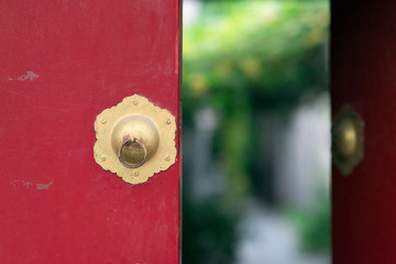  Red and gold door in Beijing with green and natural blurred bokeh in the background