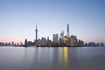 Fototapeta na wymiar Long exposure of Pudong district, modern skyscrapers and Huangpu river in Shanghai at sunrise. Urban architecture in China