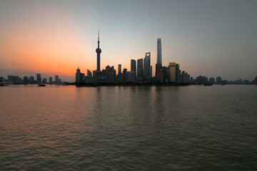 The Bund early in the morning at sunrise. View of Pudong and Huangpu river from The Bund in Shanghai, China