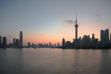 Fototapeta na wymiar The Bund early in the morning at sunrise. View of Pudong and Huangpu river from The Bund in Shanghai, China