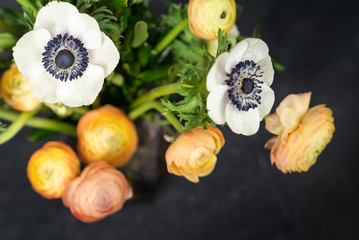 White anemone and ranunuclus oon dark background