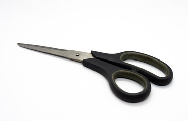 Old scissors are used for cutting various thin materials isolated on White background.