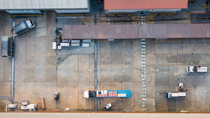 Warehouse logistic activity in Factory with forklift transport from drone aerial view.