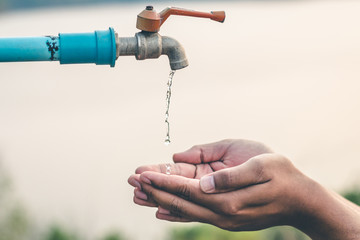 Men hand are waiting to drink water in the water shortage.