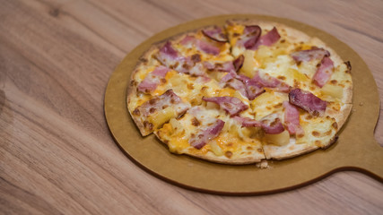 Pizza in the tray on the table