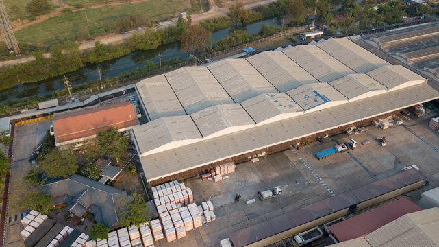 Surface Of Factory Warehouse Roof From Drone Aerial View.