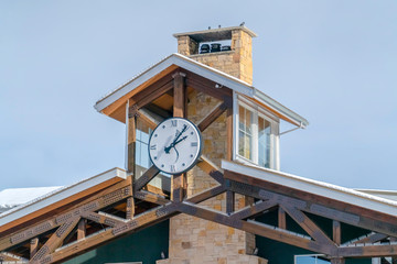 Building with a clock and snowy roof in Park City