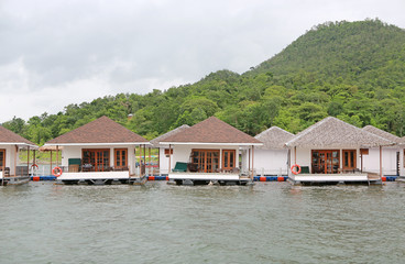 Naklejka premium Raft House floating on the river with mountain at kanchanaburi, Resort in thailand.