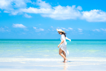 Fototapeta na wymiar Woman in the ocean with blue sky