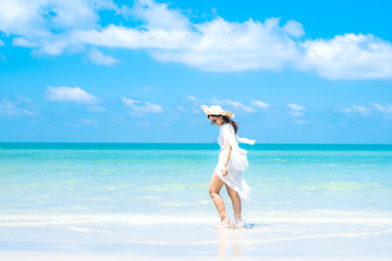 Fototapeta na wymiar Woman in the ocean with blue sky
