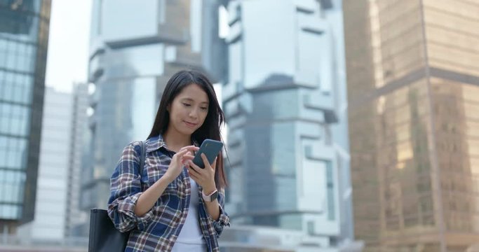 Businesswoman work on smart phone in city