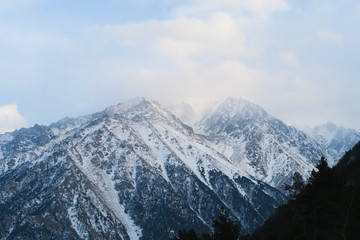 Fototapeta na wymiar Mountain range of Caucasian Mountains in the cloud sky. Syltran gorge
