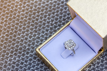 Closeup Beautiful and luxury wedding diamond ring in gold box on silver background