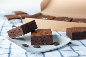 Close up sweet chocolate brownie on tablecloth