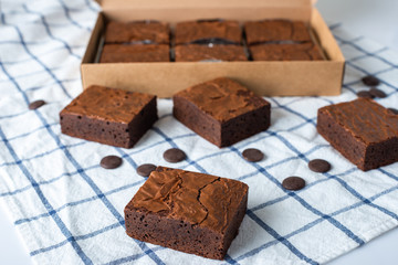 Close up sweet chocolate brownie on tablecloth