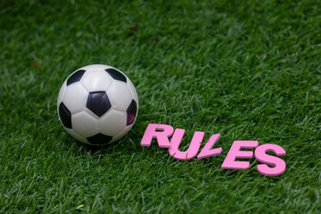 Rules of Football are on green grass 