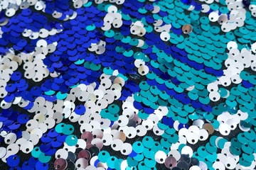 Sequins macro background.sequins in blue and turquoise tones.ridescent fabric.Scales background. fabric background. sequined textile