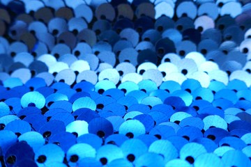 Sequins macro background.sequins in blue and turquoise tones.ridescent fabric.Scales background....