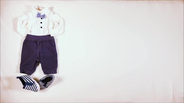 Baby boy and baby girl first date. Stop motion animation clip shot in a white table with babies' clothing 1080p 30 fps