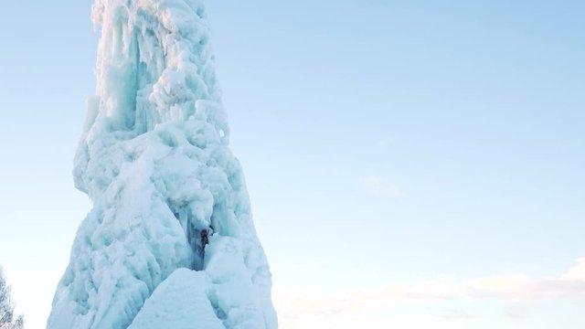 Tall iceberg inside small town in northern sweden, wide paning shot on tripod during sunrise