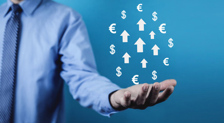 Man holding arrows with currency symbols. Business growth and success concept