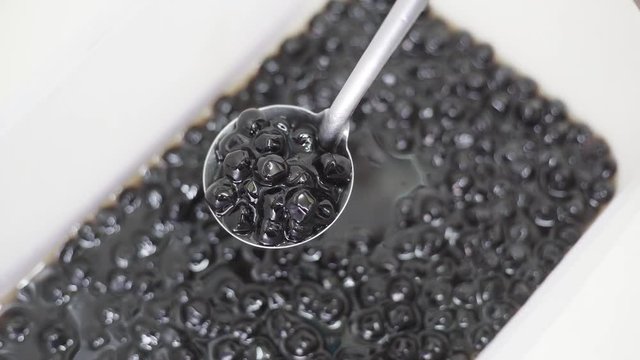 Dip black tapioca balls or pearl milk tea by dipper 