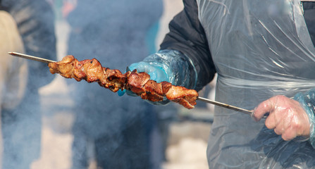 Shish kebab on sticks fried on coals in nature