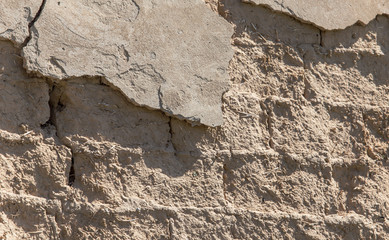 Old clay bricks wall as background