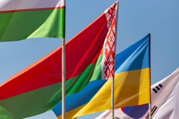 Flags of countries against a blue sky