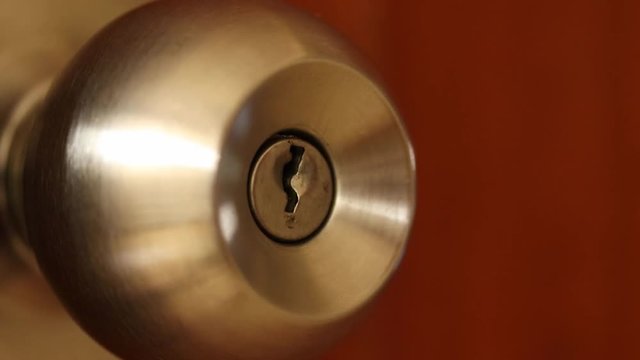 Close-up of hand is using a key unlocking the door