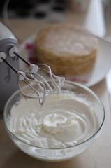whisking mixer white butter cream to assemble the cake on the occasion