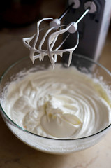 whisking mixer white butter cream to assemble the cake on the occasion